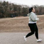Energy Audit - Plus size woman running in autumn park