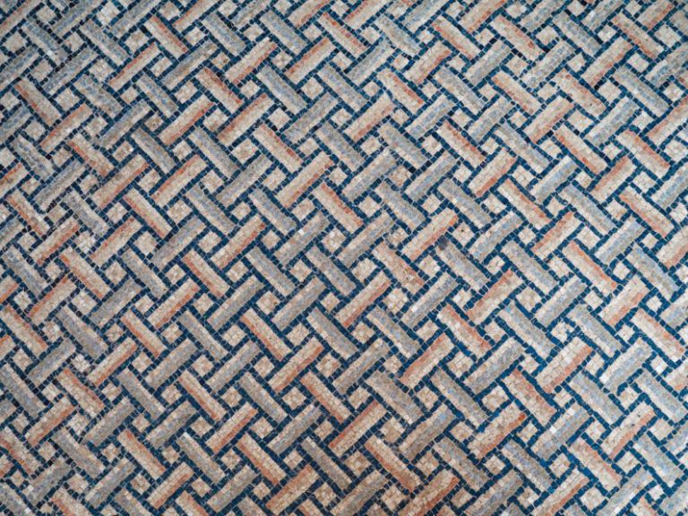 Mixed Patterns Decor - a close up of a blue and brown rug